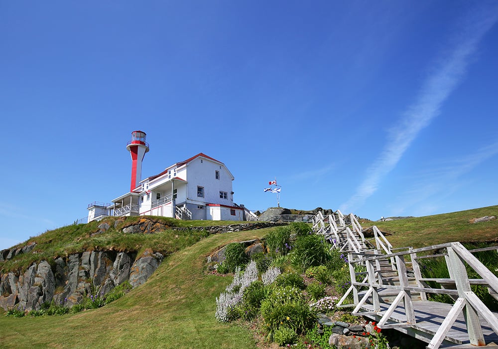 An image rendering of a lighthouse on top of a hill.