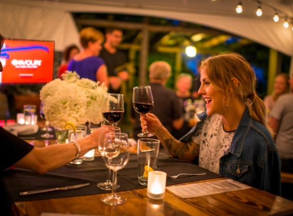 Two people with glasses of wine at Devour Film Festival