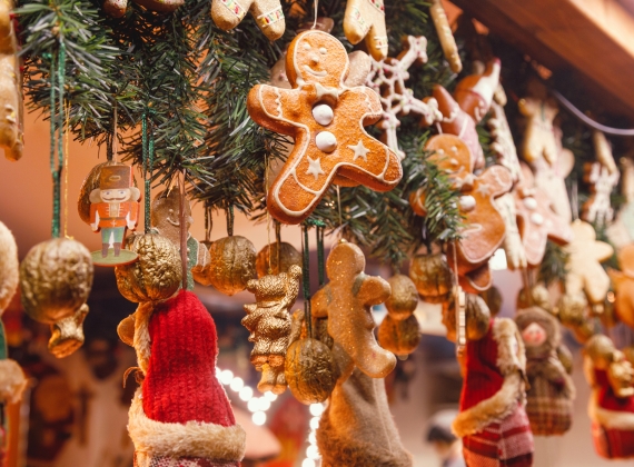 Gingerbread man and other Christmas themed decorations hanging from stall banister