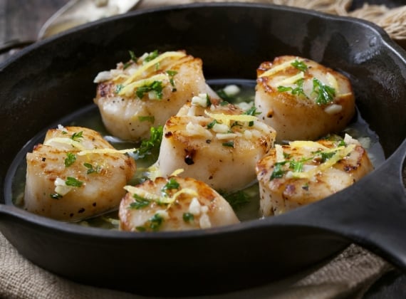 Scallops being cooked in a frying pan