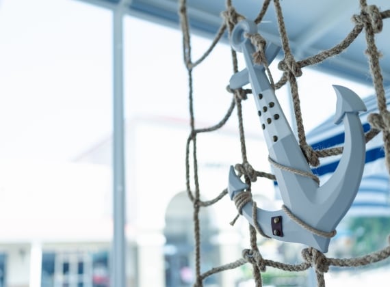 A decorative anchor hanging from rope 