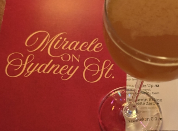 Image of the Miracle on Sydney Street menu and two drinks 