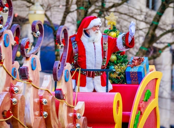 Santa Claus on a sleigh during a parade 