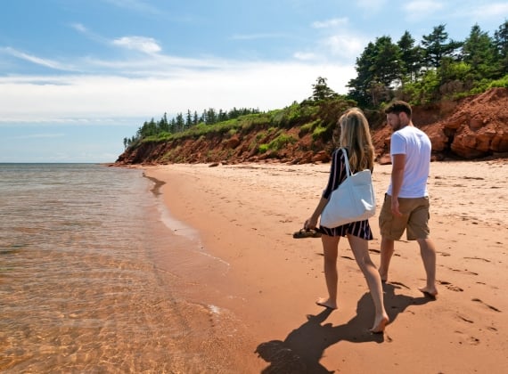 people walking along the beach