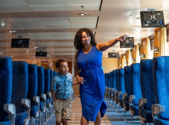 Mom and son walking through the aisles on the ferry
