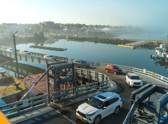 Cars driving onto ferry