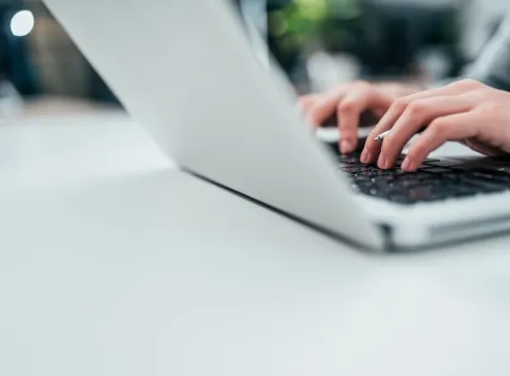 Female typing on her laptop