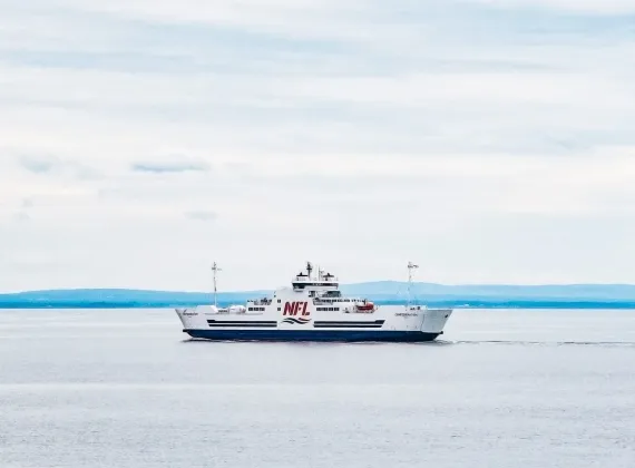 A large ferry sailing in the ocean on a calm day.