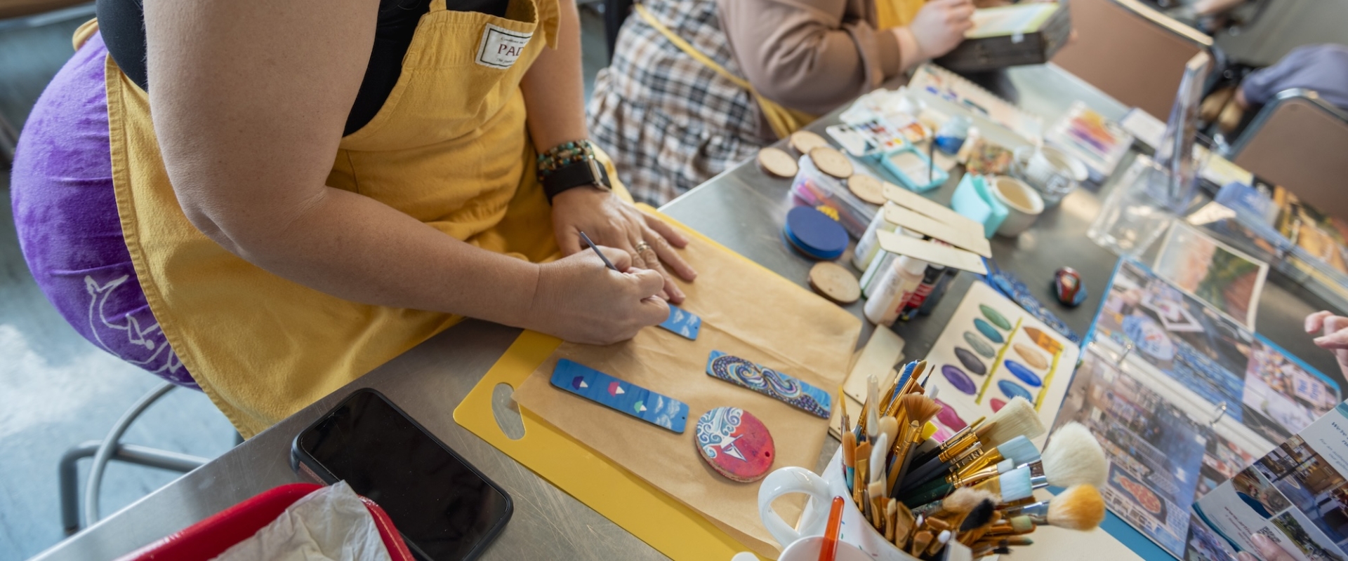 Two people making crafts on the ferry 